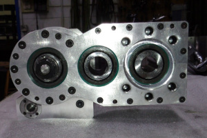Gear box with manual draw bar at left, idler gear in center and motor mount at right
