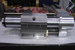 Quill spindle with spindle nose at left, quill clamp housing in the center and flange and gear box to the right
