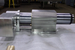 Gear box at left, guide rod and quill clamp housing in center and spindle nose at right