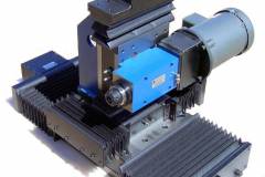 MB275/LBW8/LBW8/LBW12: one spindle and three axis slide assembly with linear ball bearings, ground ball screws and motor mounts. Used to mill a chamfer on an aluminum part.